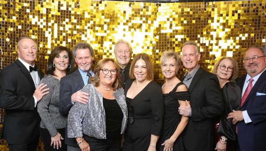 A group of friends in evening wear at a past New Years NJ gala