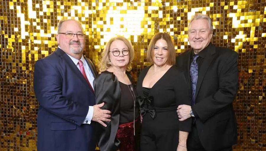 Two couples dressed up for New Year's Eve